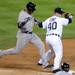 Detroit Tigers' pitcher Phil Coke beats Yankees' batter Robinson Cano to first base for an out in the eighth inning during Game 4 of the ALCS in Detroit on Thursday night.